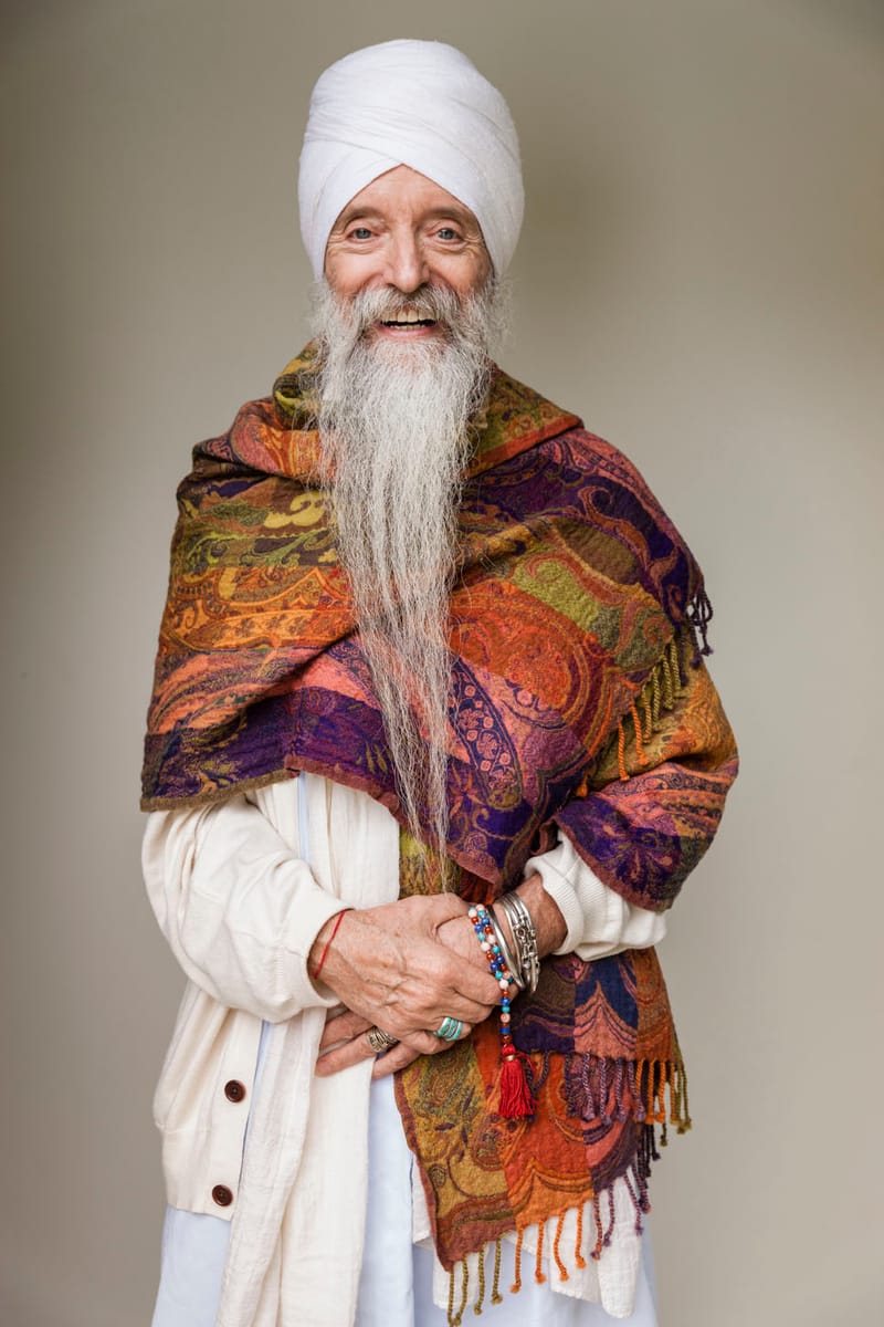 Guru Singh, smiling, in a white turban and a patterned shawl
